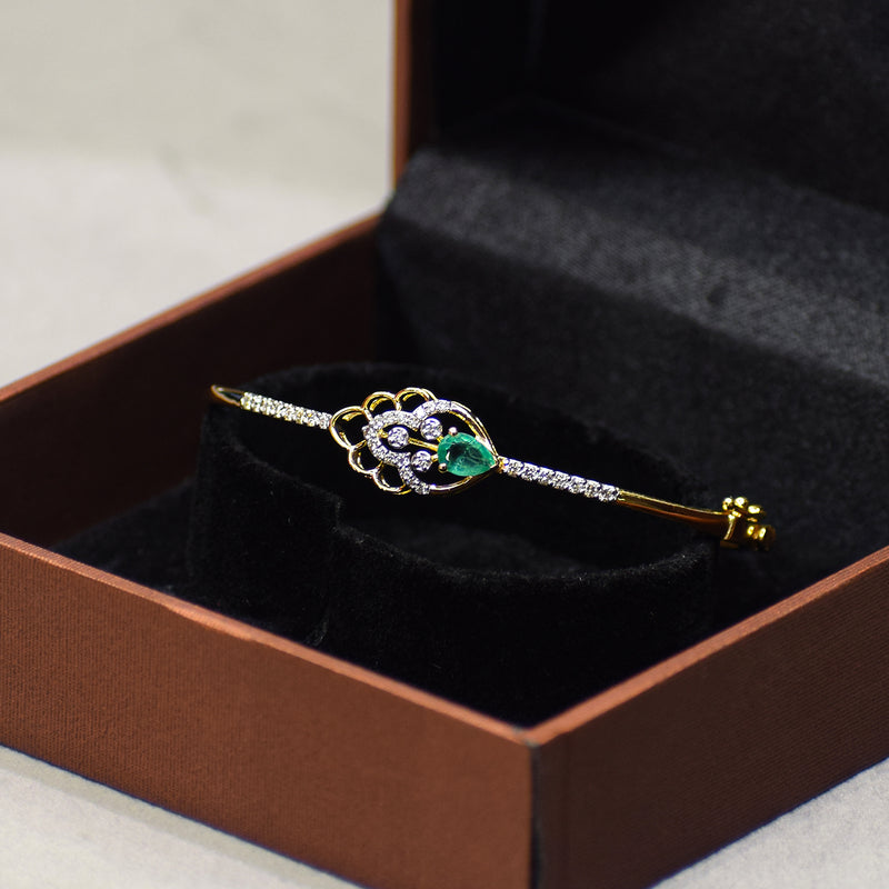 Floral pattern bracelet with green colored stone