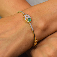 Floral pattern bracelet with green colored stone